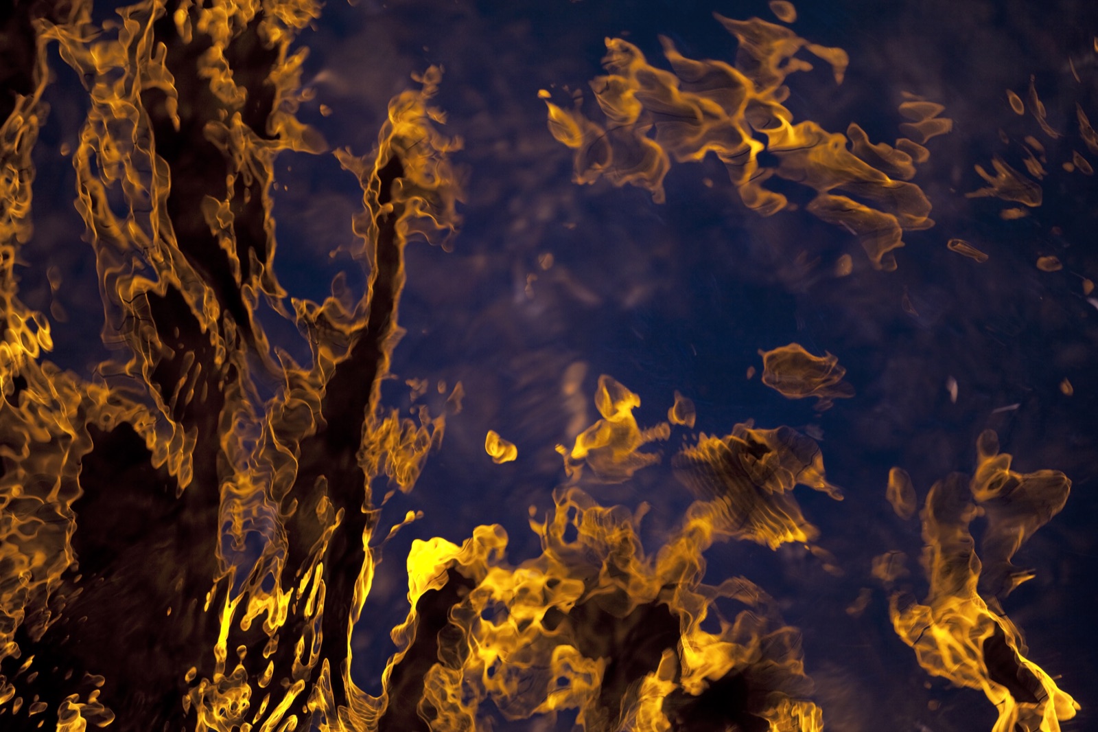 Abstract orange reflections on dark water