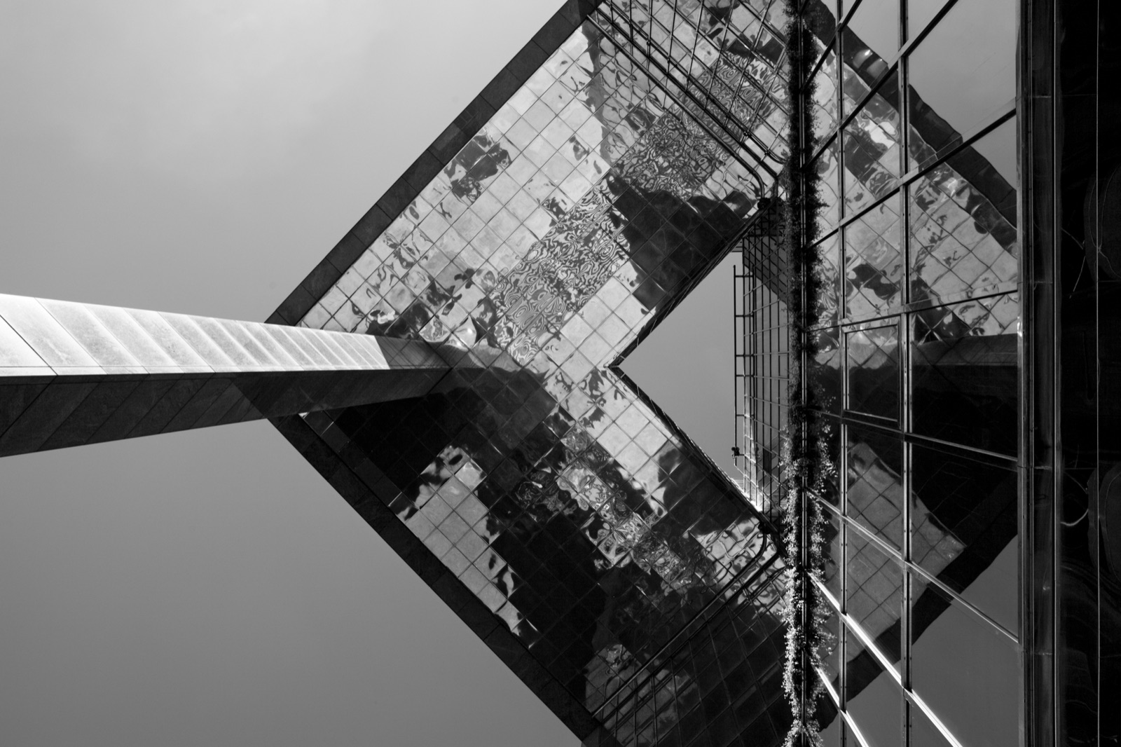 Black-and-white photograph of reflective modern architecture